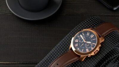 freepicdownloader.com men s wrist watch black tie cup hot coffee smartphone wooden table normal