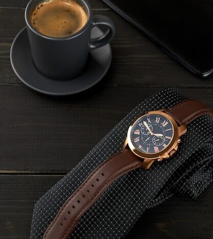 freepicdownloader.com men s wrist watch black tie cup hot coffee smartphone wooden table normal